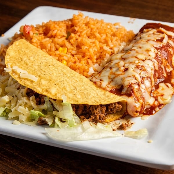 A plate with a hard-shell taco, an enchilada covered in melted cheese and sauce, and Spanish rice.